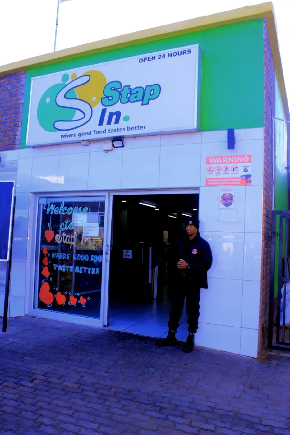 Willy's security guard in uniform at the door of a 24-hour shop in Upington